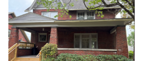a brick house with a large front porch