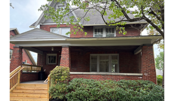 a brick house with a large front porch