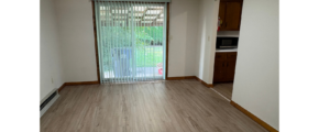 an empty living room with a sliding glass door