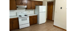 a kitchen with white appliances and wooden cabinets