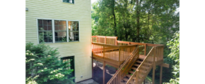 a house with a deck and stairs leading up to it