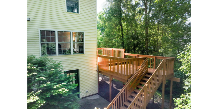 a house with a deck and stairs leading up to it