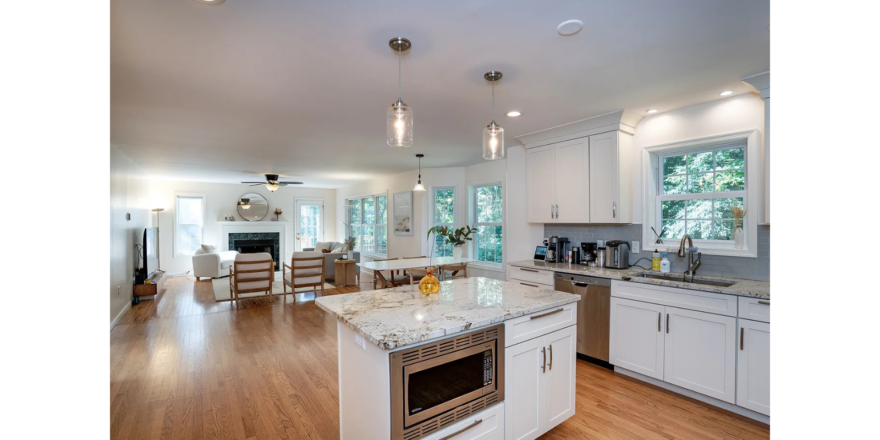 a large kitchen with a center island in the middle of the room