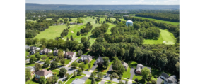 a bird's eye view of a golf course surrounded by trees
