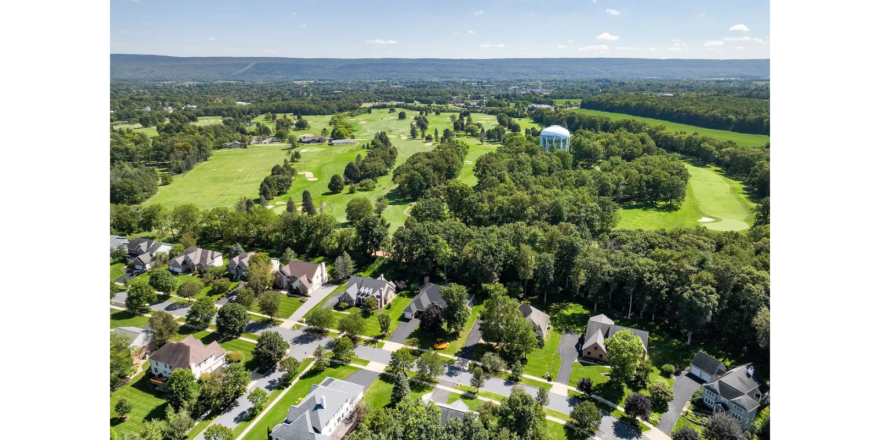 a bird's eye view of a golf course surrounded by trees