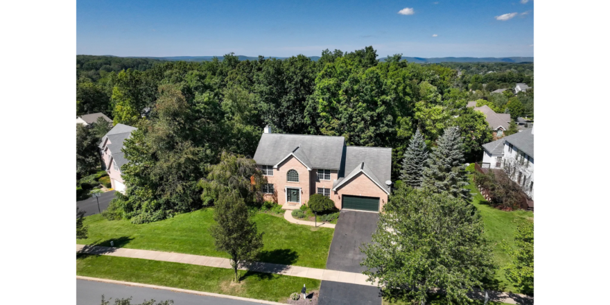 an aerial view of a home in a wooded area