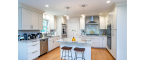 a kitchen with white cabinets and wooden floors