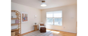 a living room with hard wood floors and white walls