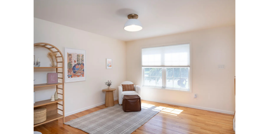 a living room with hard wood floors and white walls