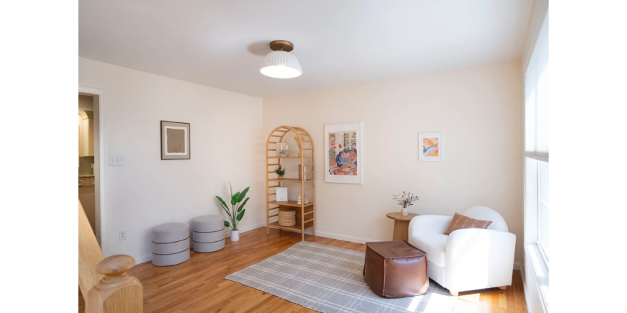a living room filled with furniture and a wooden floor