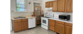 a kitchen with white appliances and wooden cabinets
