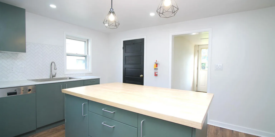 a kitchen with a large island in the middle of it