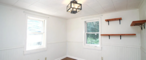 a empty room with wood floors and white walls