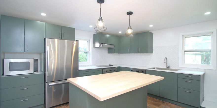 a large kitchen with a center island in the middle of the room