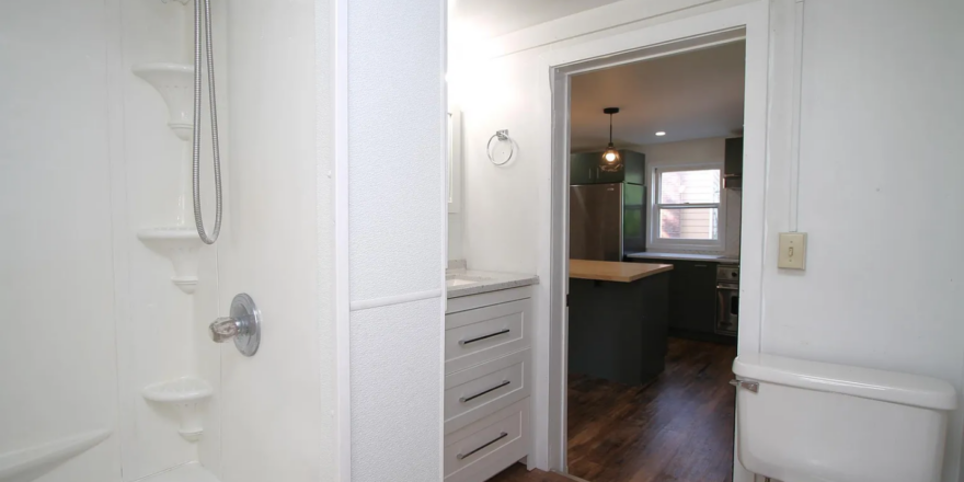 a bathroom with a toilet, tub, and sink