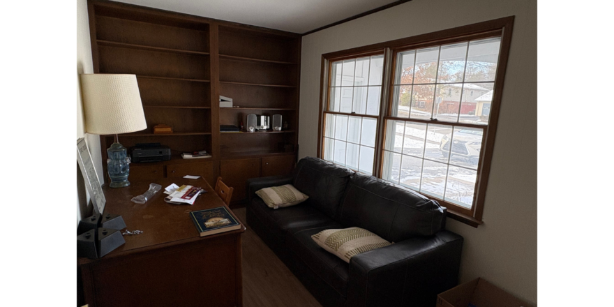 a living room with a couch and a desk