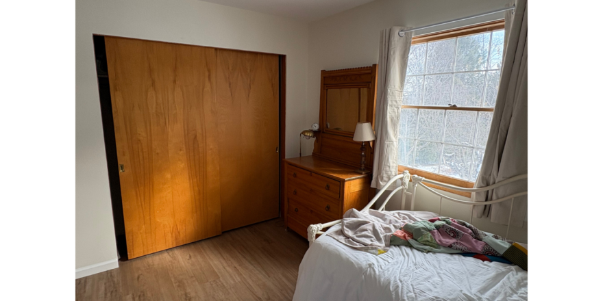 a bedroom with a bed and a dresser