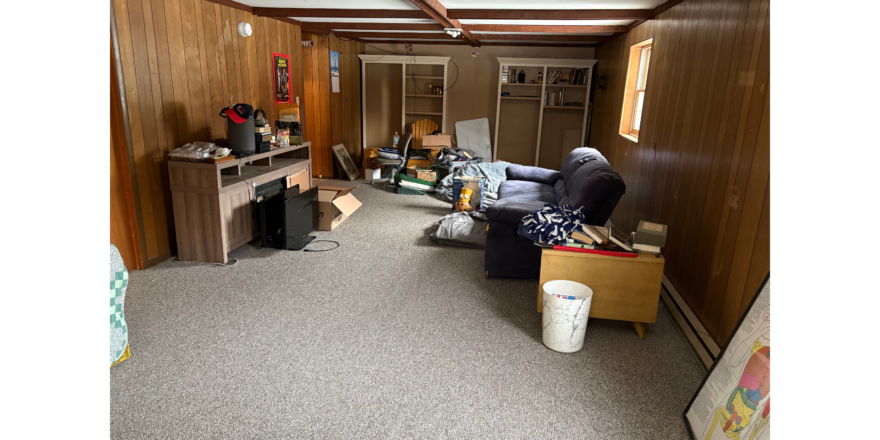 a living room with a couch and a desk