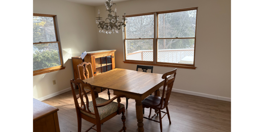 a dining room with a table, chairs and a chandelier