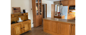 a kitchen with wooden cabinets and a refrigerator