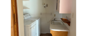 a kitchen with a washer and dryer in it