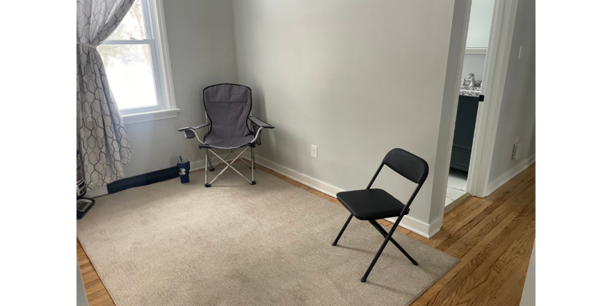 a chair and a mirror in a room