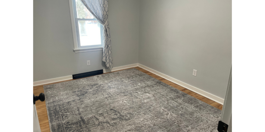 a room with a carpet and a window