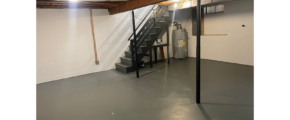 an empty garage with stairs and a fire hydrant
