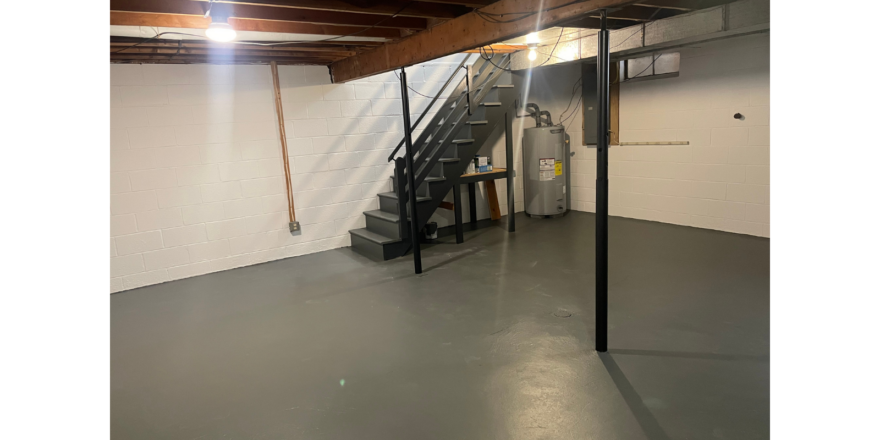 an empty garage with stairs and a fire hydrant