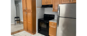a kitchen with a refrigerator, stove and cabinets