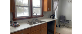 a kitchen with a sink, dishwasher and a window