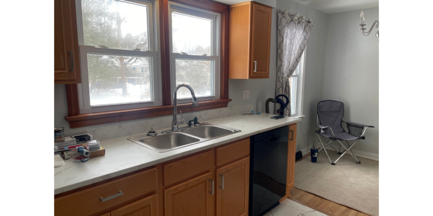 a kitchen with a sink, dishwasher and a window