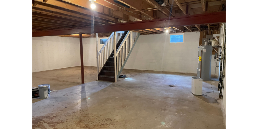 an empty room with a staircase leading up to the second floor