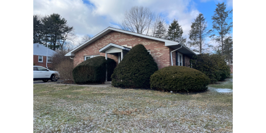 a house with a car parked in front of it