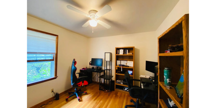 a living room with hard wood floors and a ceiling fan