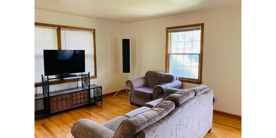 a living room with a couch a chair and a television