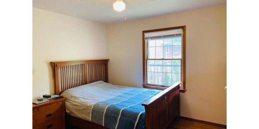 a bedroom with a bed and a window