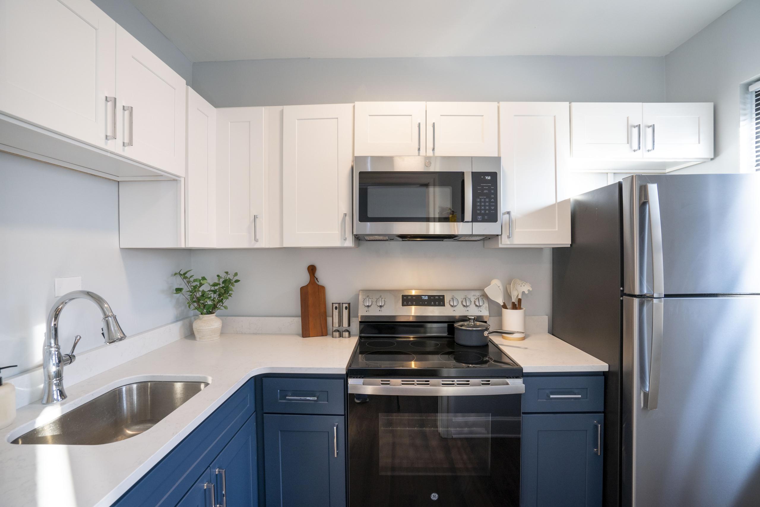 a kitchen with a stove, refrigerator, sink and dishwasher