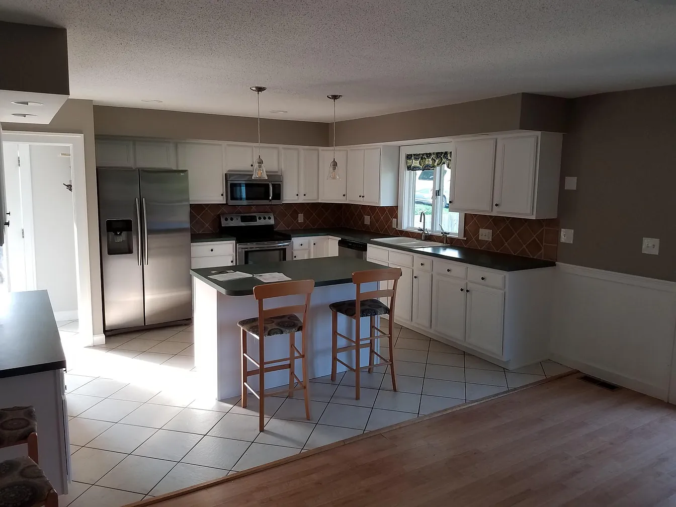Kitchen with island and stainless steel appliances