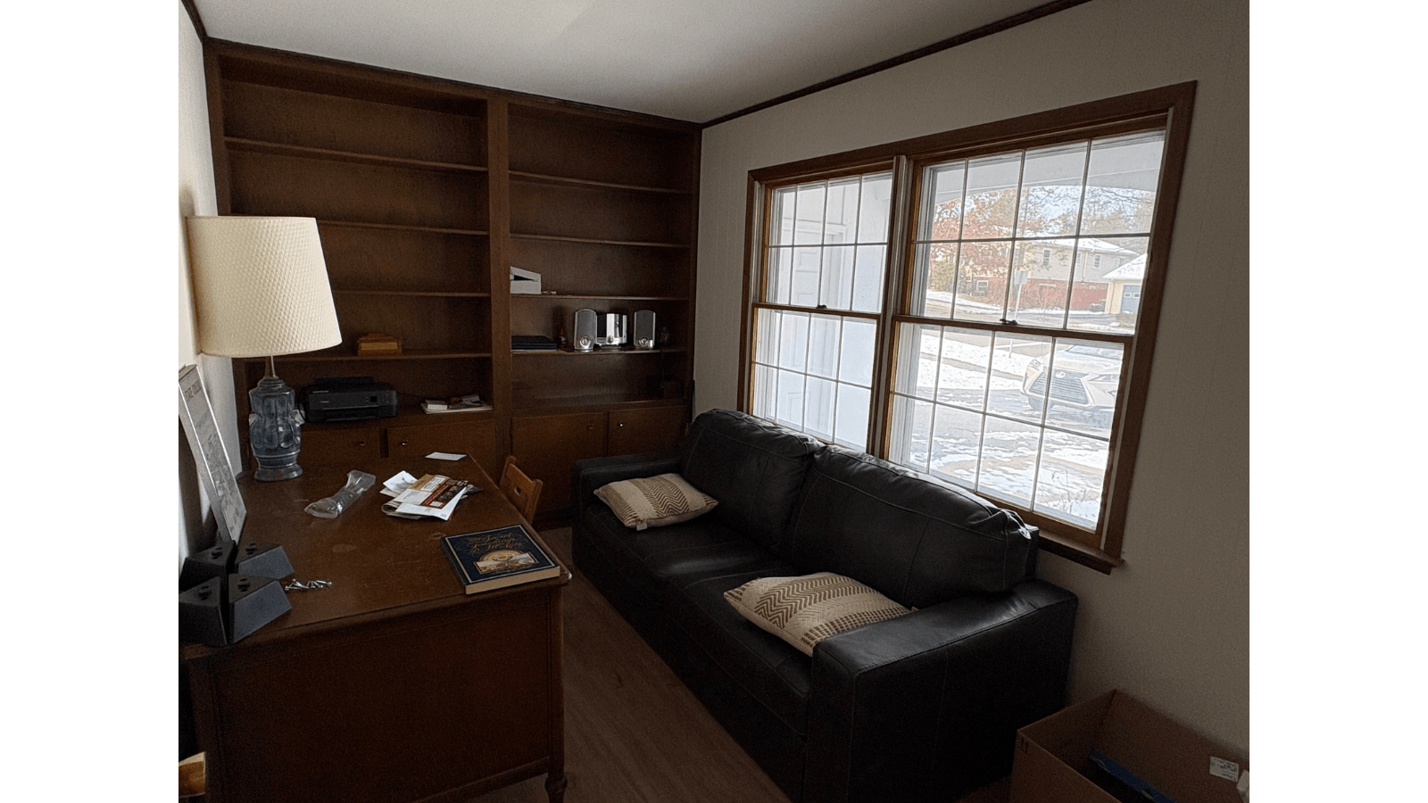 Leather couch and bookshelf in a home office