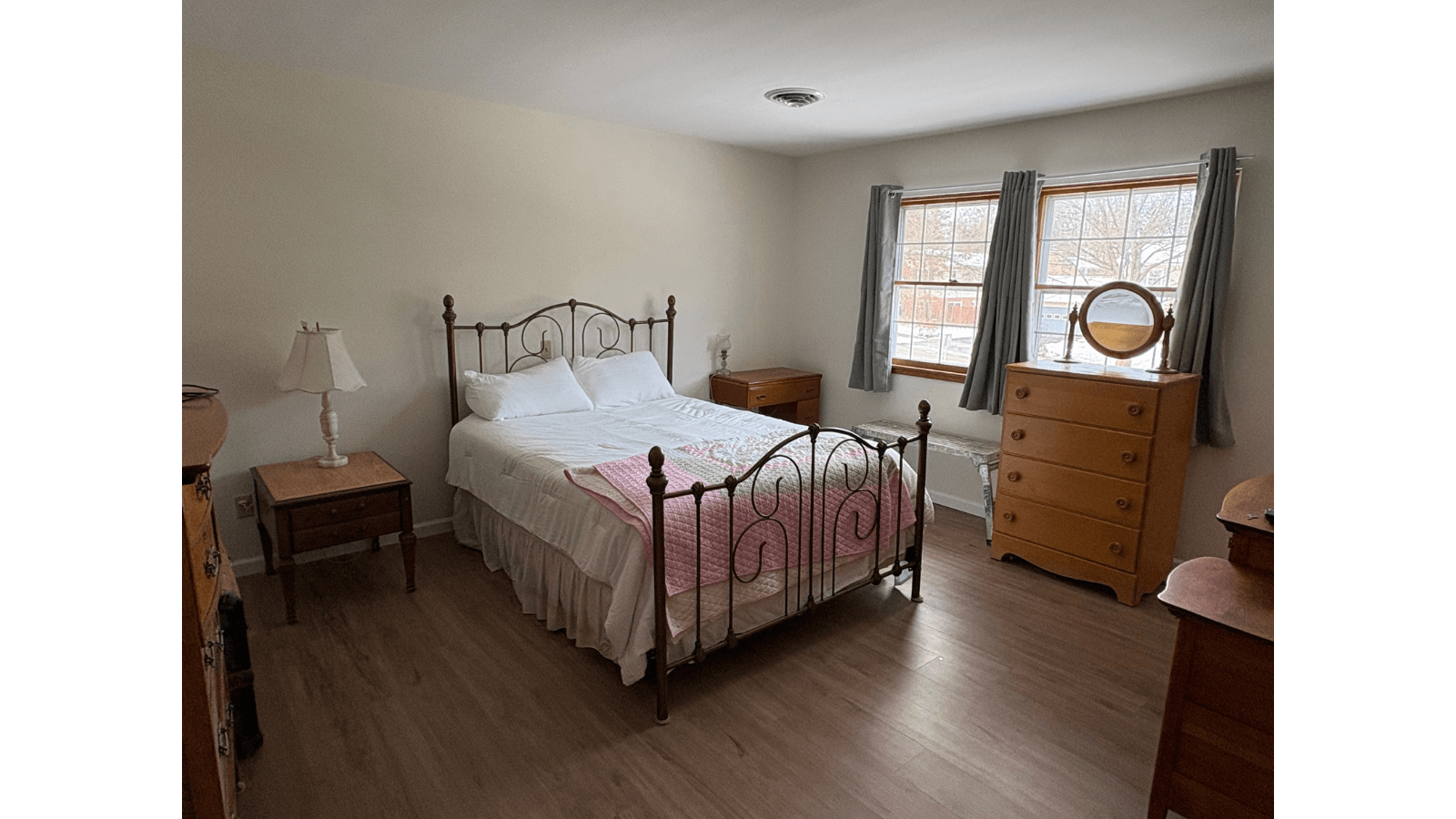 Bedroom with queen bed and dresser