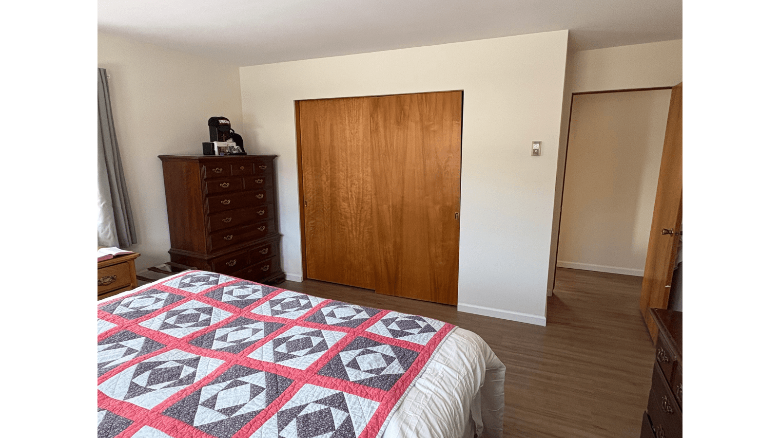 Bedroom with quilt and closet doors