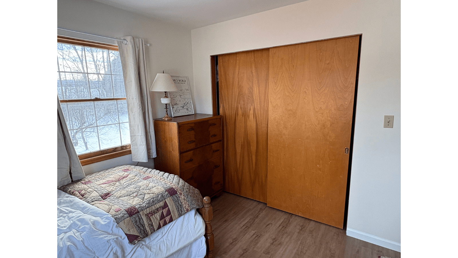 Bedroom with bed, dresser, and closet