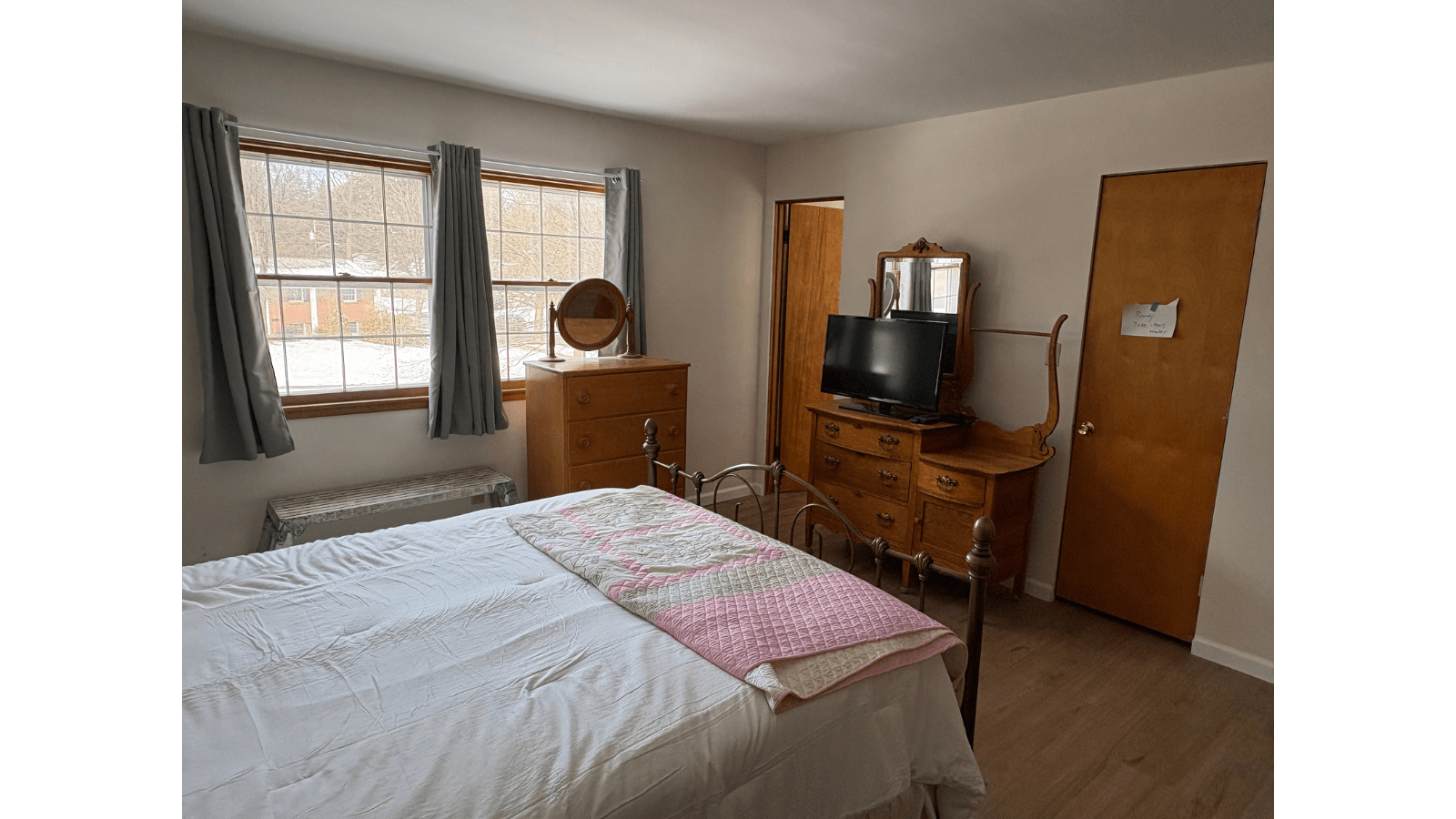 Bedroom with bed, dresser, and TV