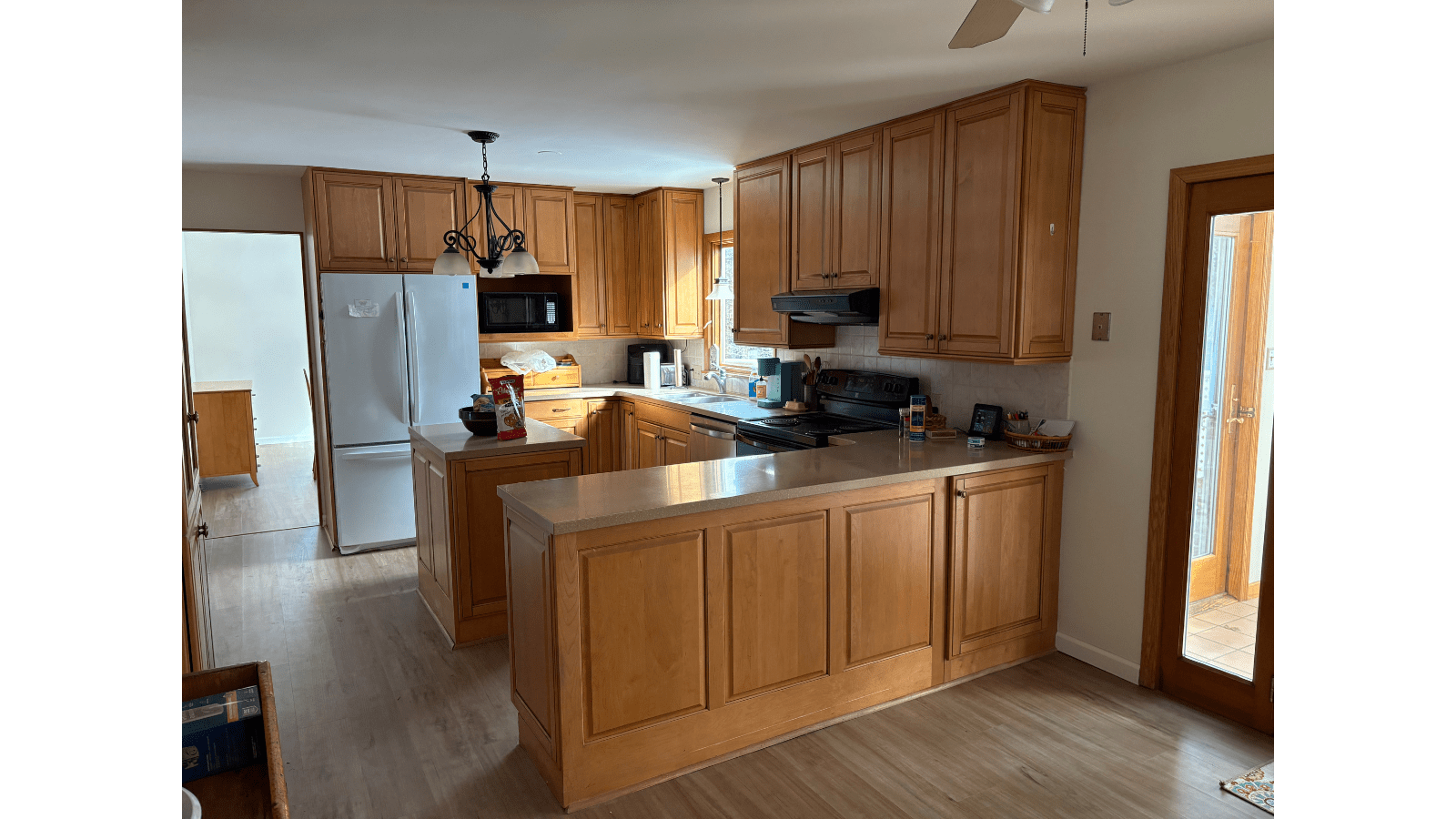 Light wood kitchen with island and refrigerator