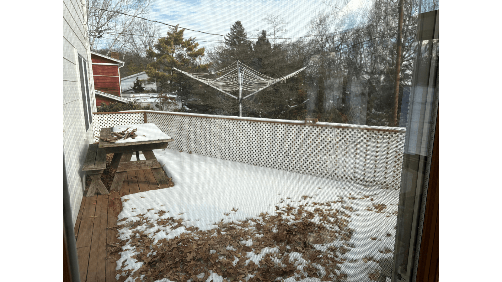 Deck with snow and fallen leaves