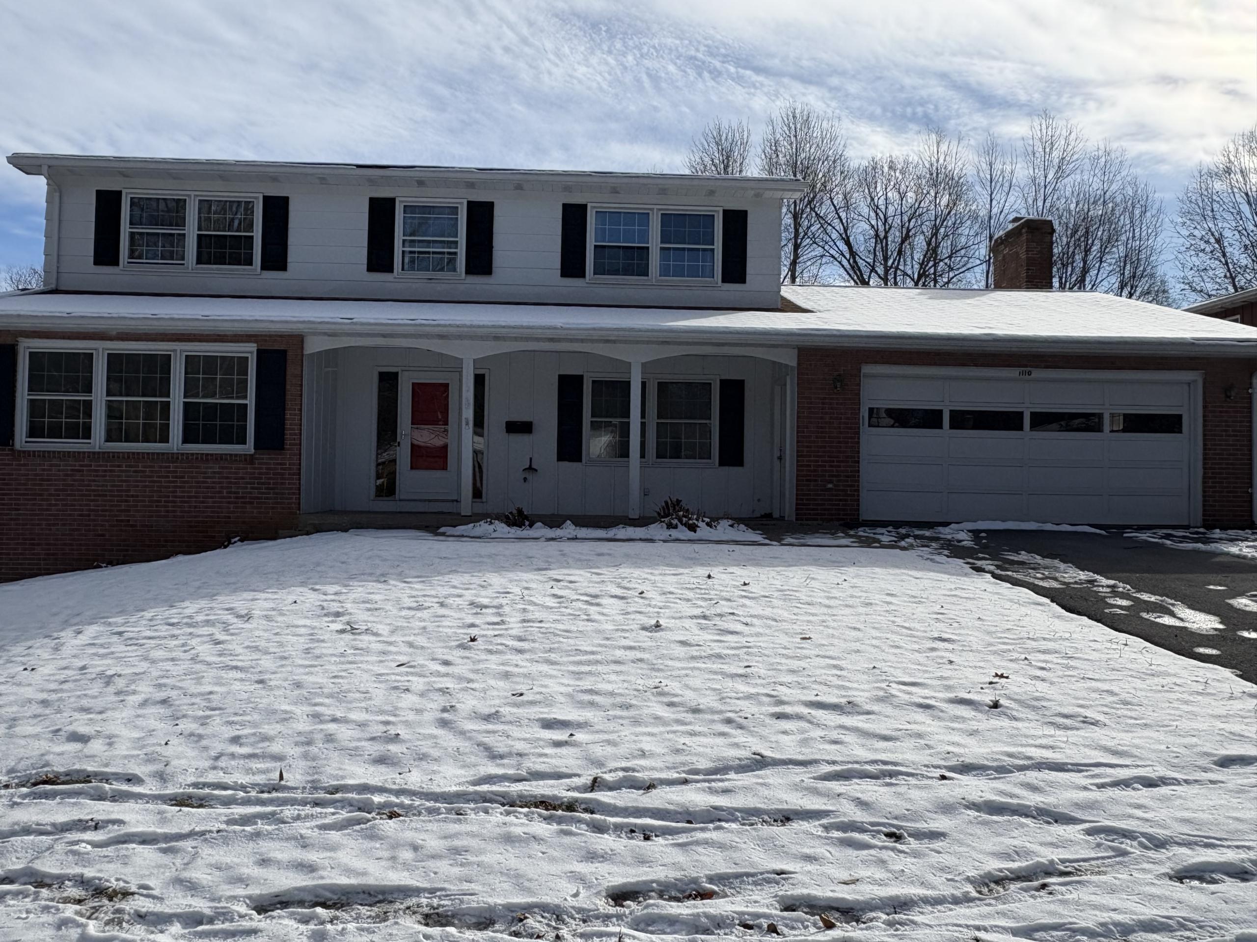 1110 Westerly Pkwy house with covered front porch with garage and driveway on right.