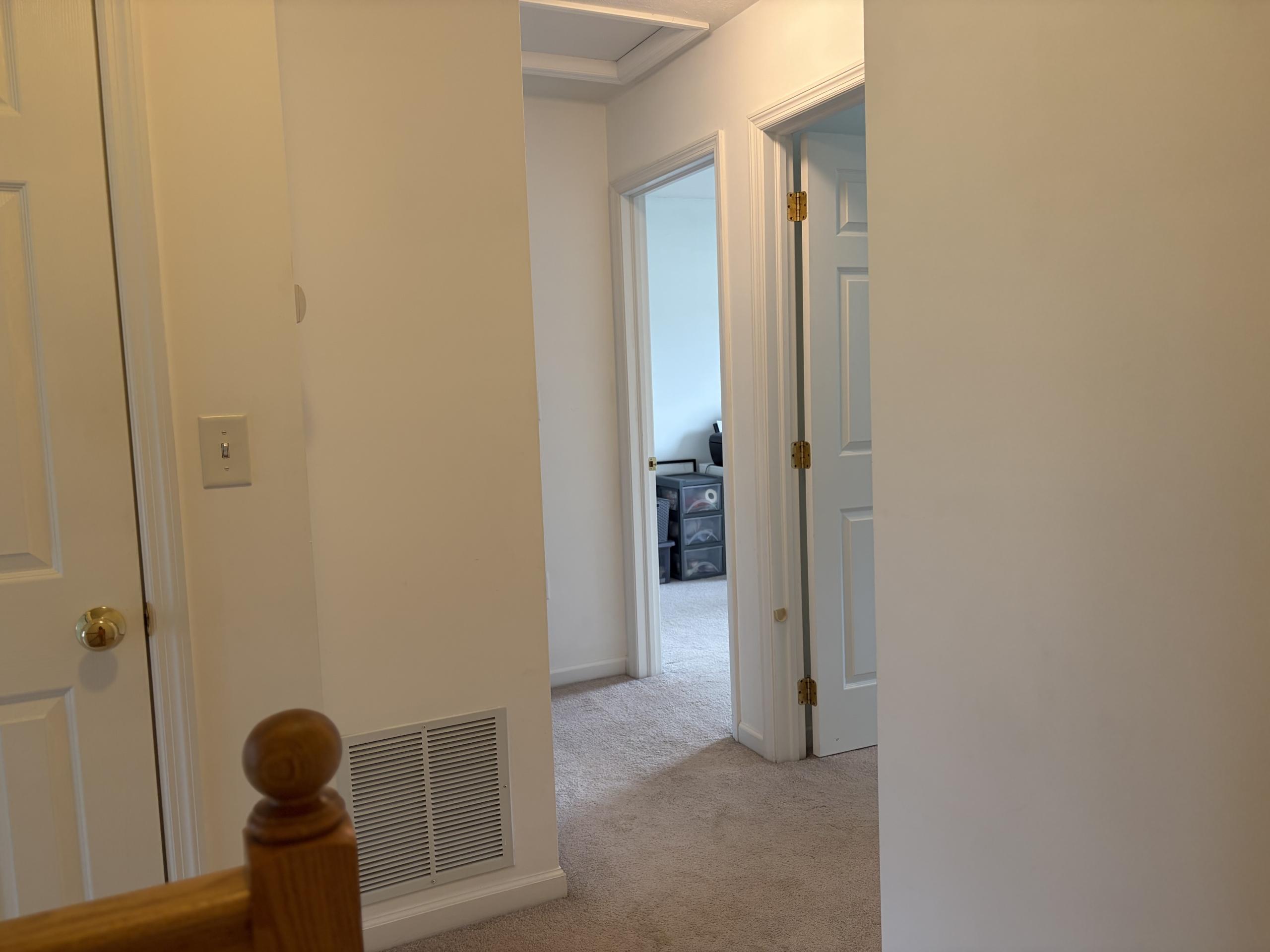 Hallway with doors and vent