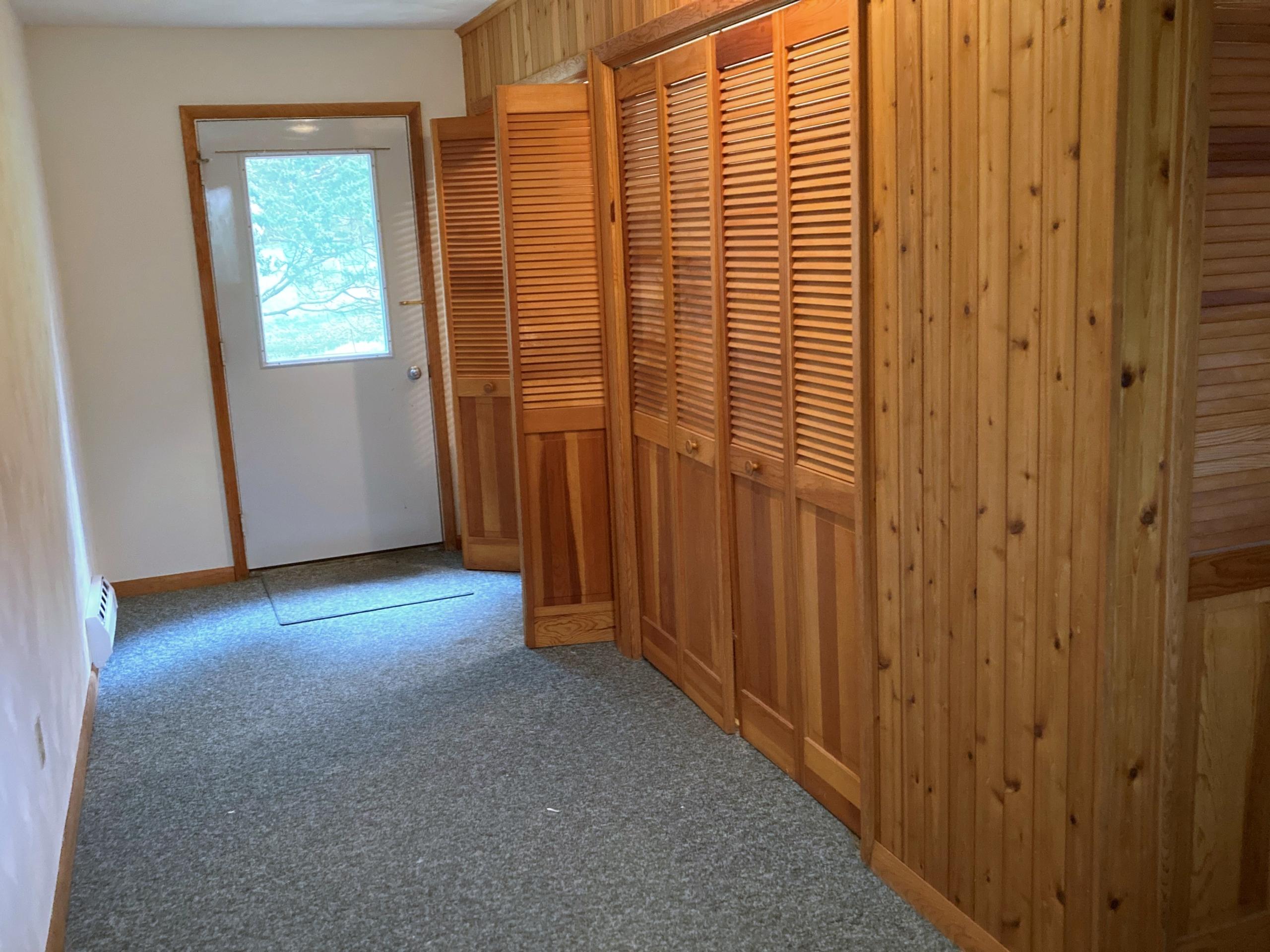 Hallway with louvered closet doors