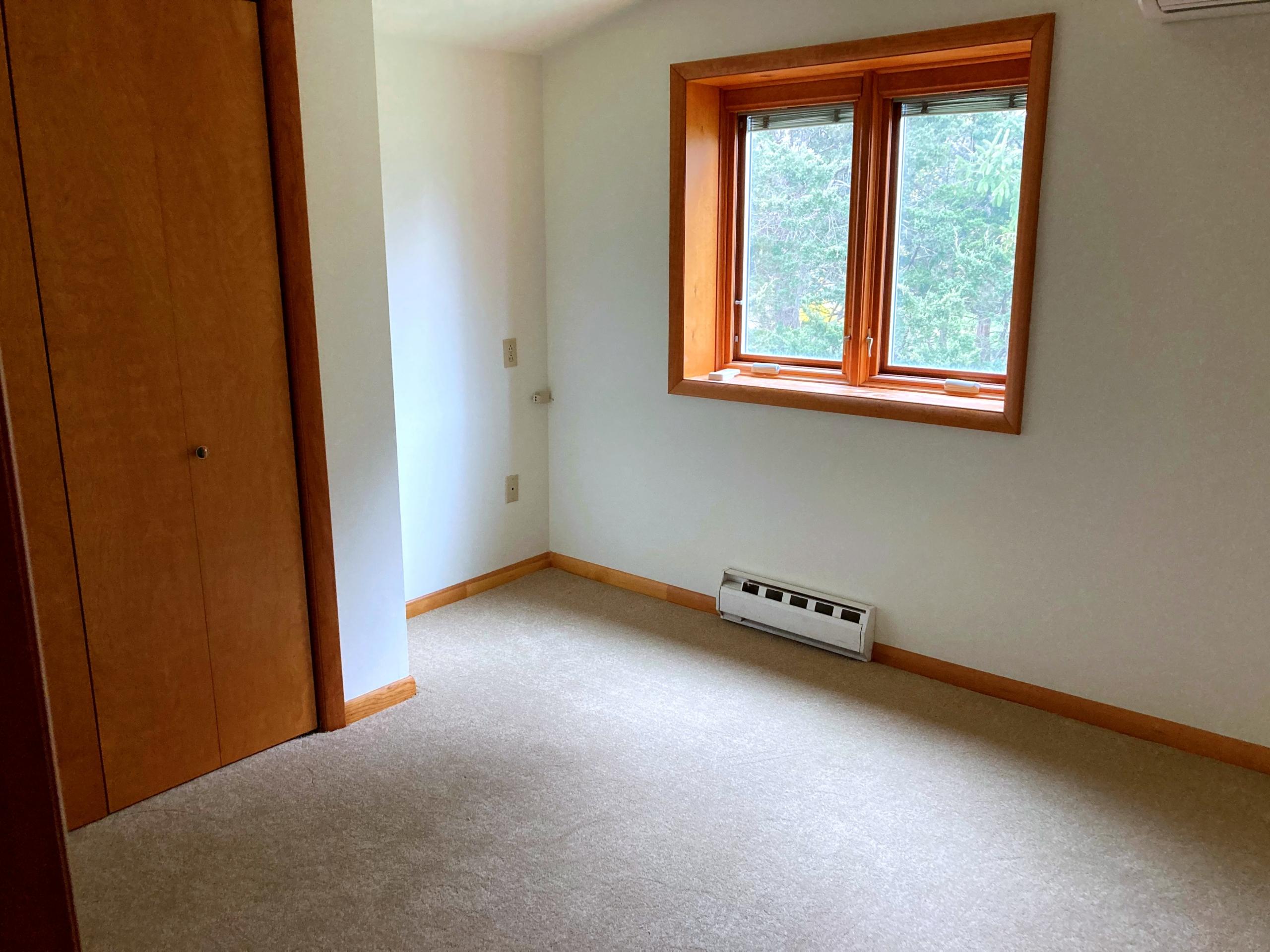 Empty room with closet and window